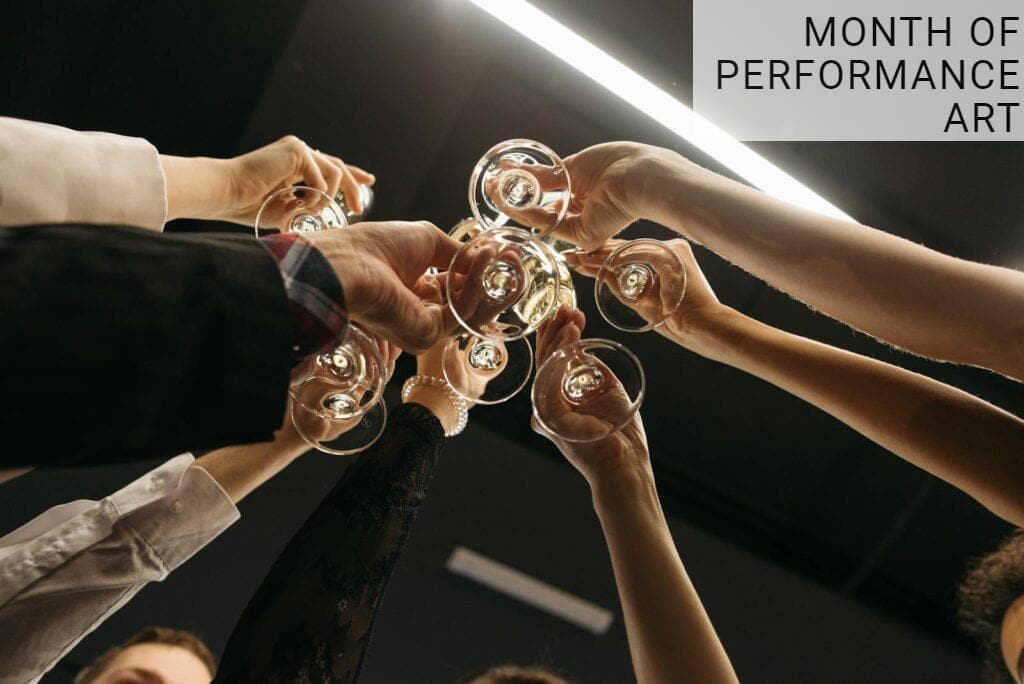 A festive gathering with people toasting with champagne glasses in a low angle shot.